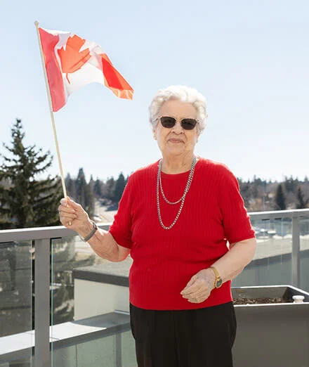 elder woman holding canada flag